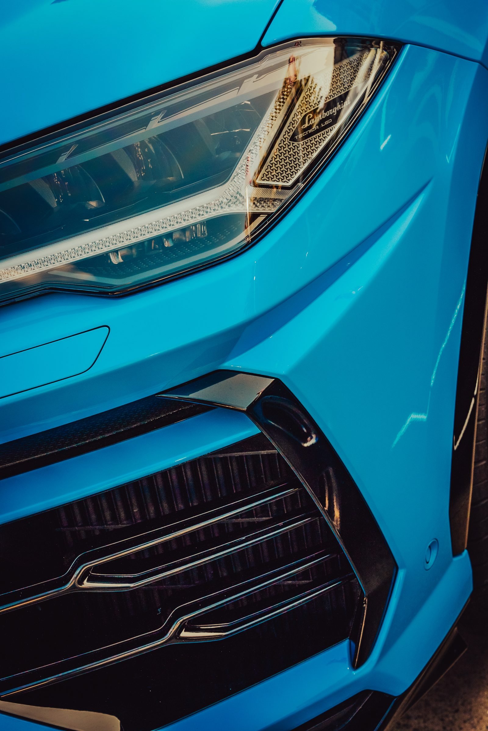 Front guard of the same performance car design in bright blue