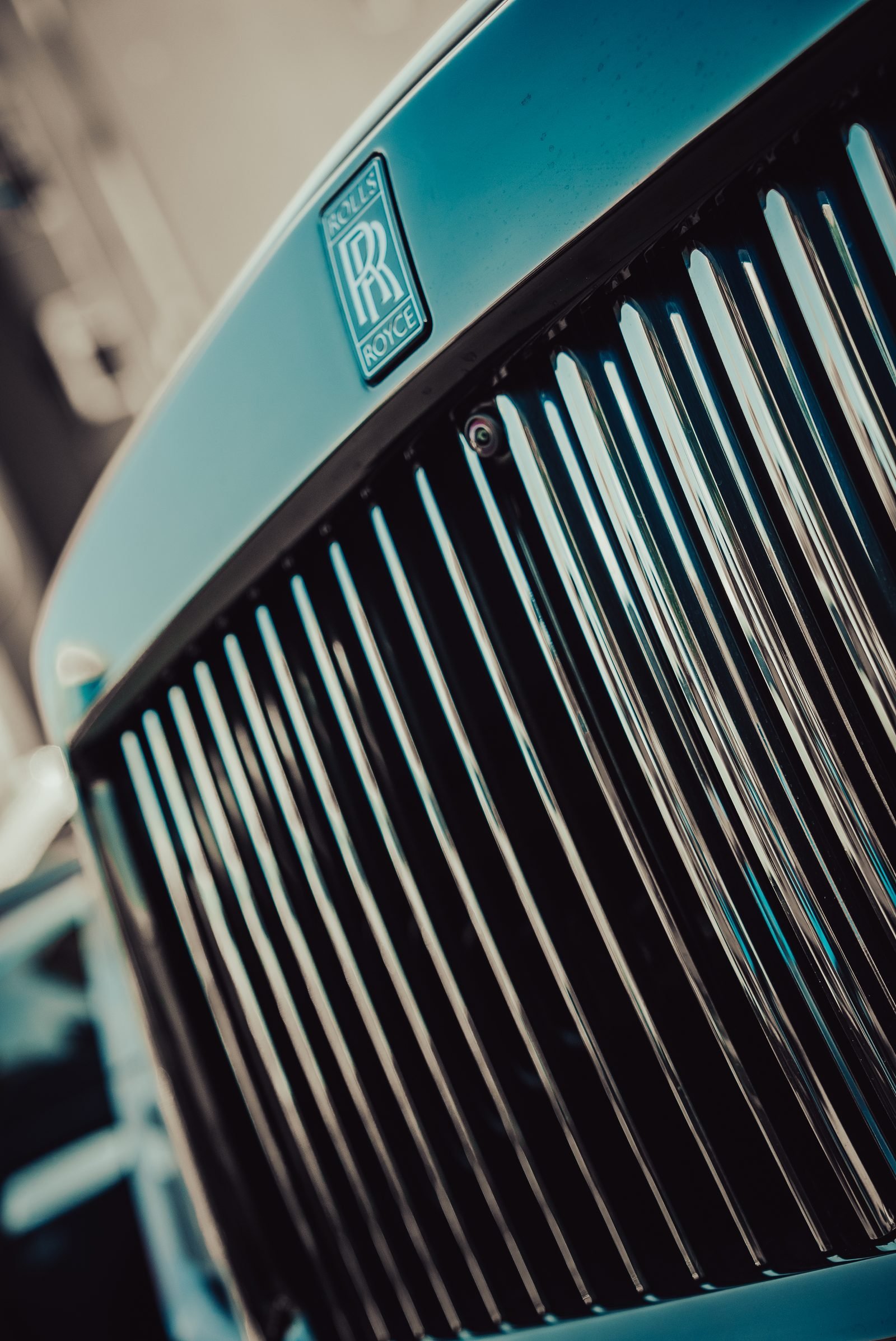 Upright black grille bars catching thin lines of light