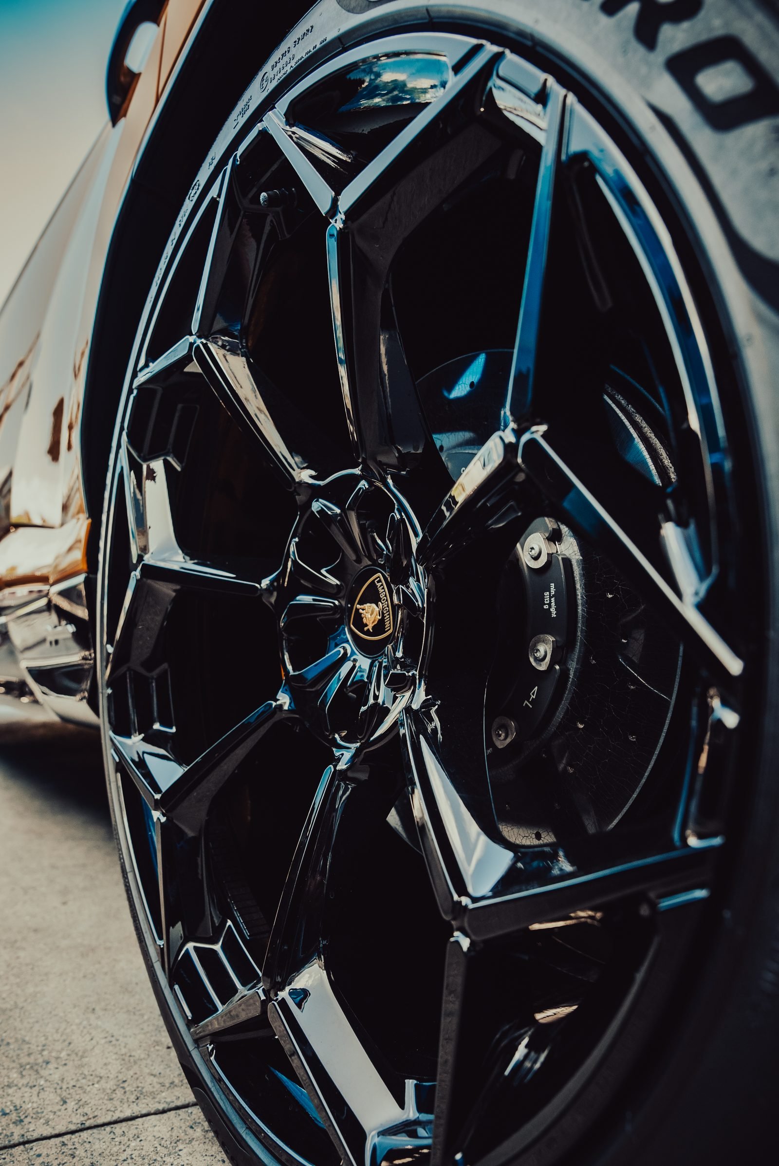 Black forged wheel with sculpted spokes, seen from low and close