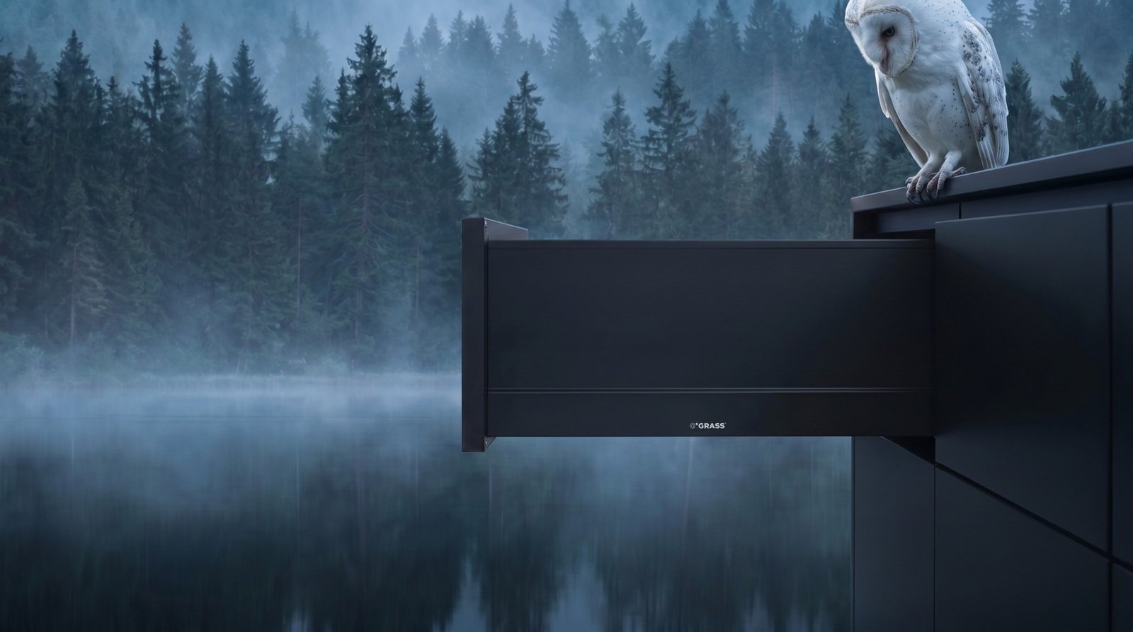 GRASS branded drawer open over a misty lake at dawn, with a white barn owl perched above